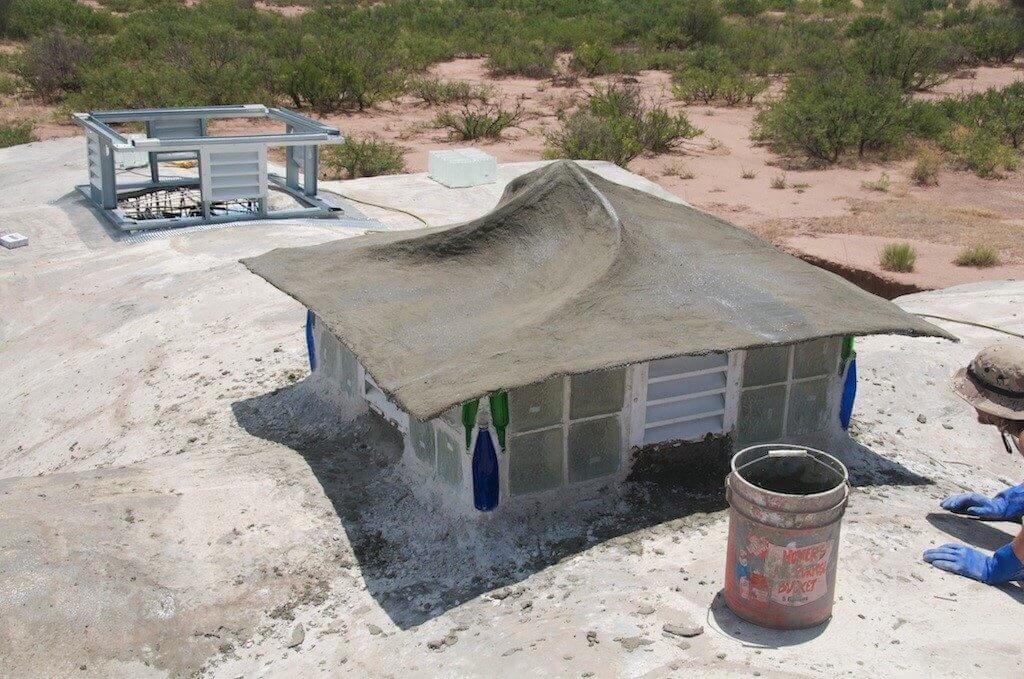 A mix of ferrocement of cement and sand (in a 1:3 ratio) reinforced by closely-spaced layers of small diameter wire mesh used in the construction of roof of the house. 