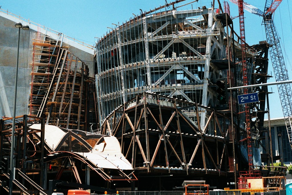 construction images of the Walt Disney Concert Hall, revealing the various stages of the building process, construction workers, and the intricate steel framework, showcasing the remarkable engineering and construction efforts that brought this iconic concert hall to life in Los Angeles.