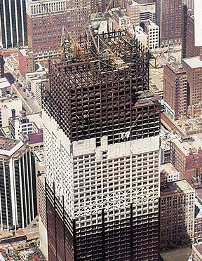 the Willis Tower during its construction phase, showcasing the partially completed structure, cranes, and workers, illustrating the ambitious construction efforts and engineering marvels that brought this iconic skyscraper to life in Chicago