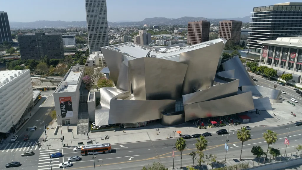 iconic Walt Disney Concert Hall, featuring its unique stainless-steel exterior, curvaceous forms, and intricate architectural details, representing the harmonious blend of art, music, and architecture in the heart of Los Angeles