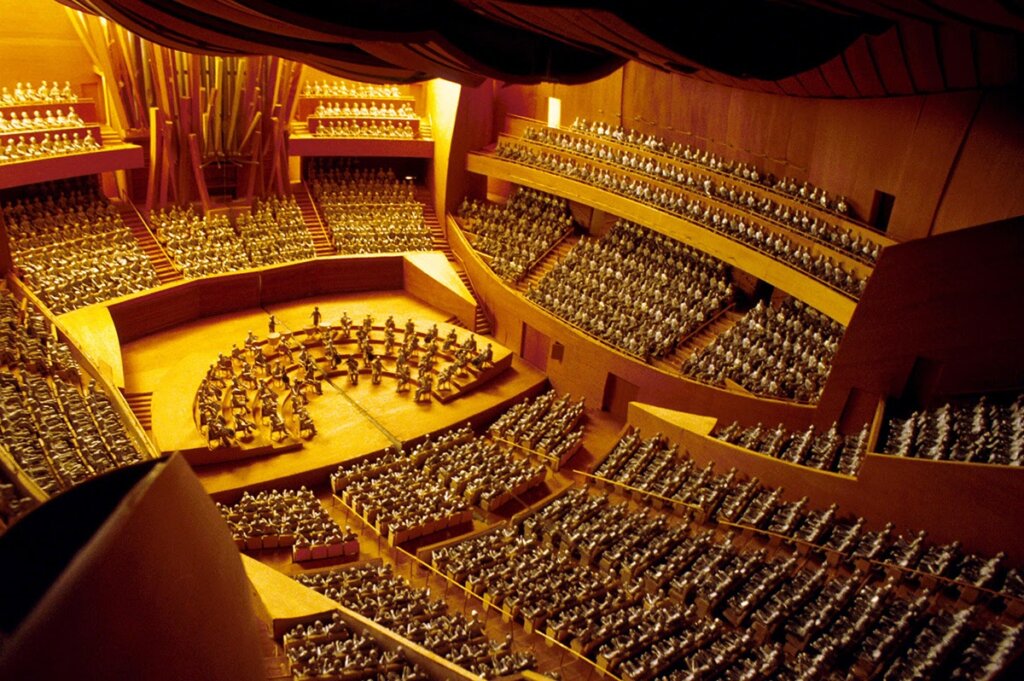 breathtaking interior of the Walt Disney Concert Hall, featuring its stunning acoustics, elegant seating arrangement, and intricate architectural details, creating an immersive and captivating environment for musical performances in Los Angeles.